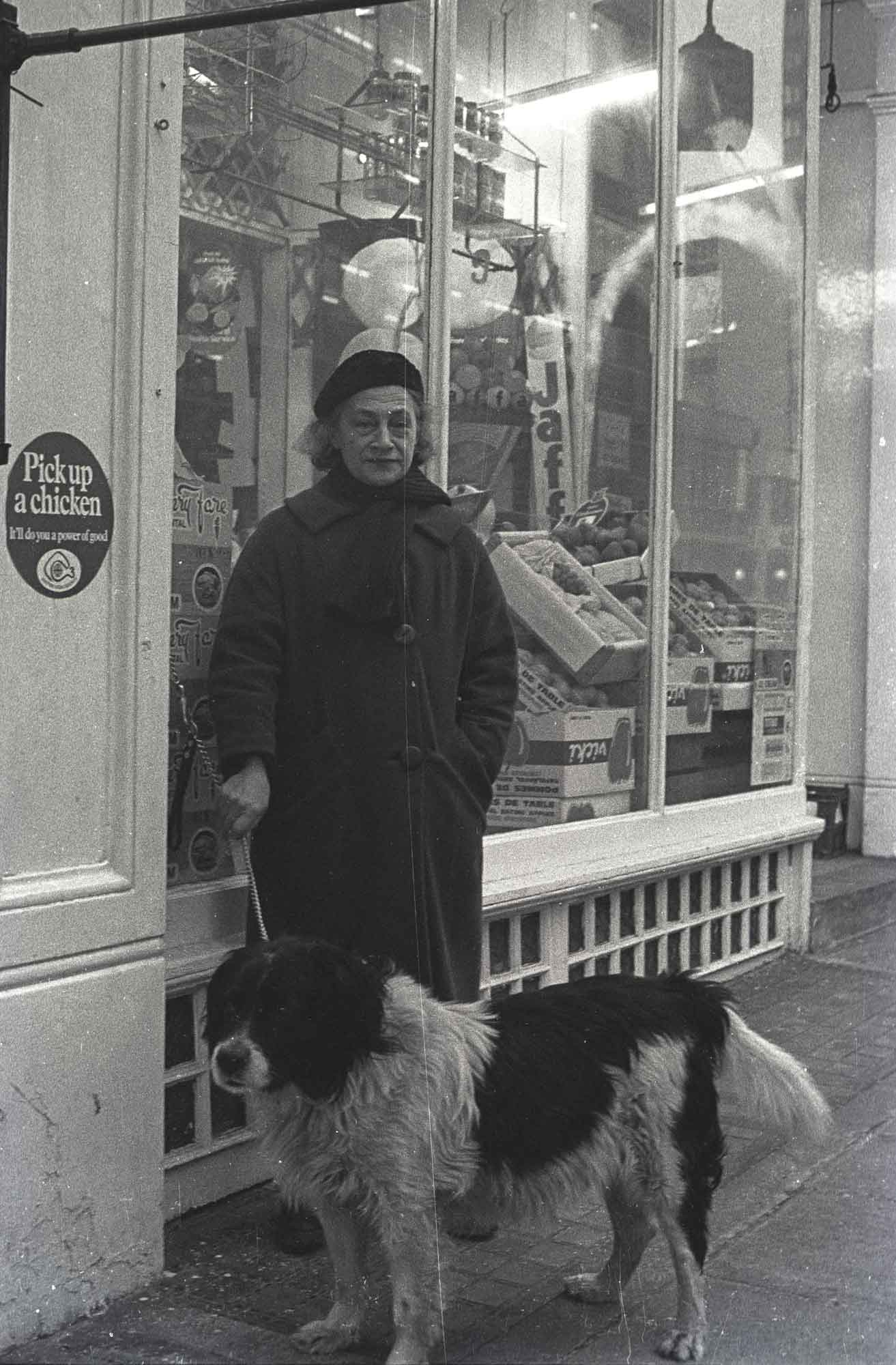 Adrienne with dog outside Dennys in Hampstead Road, 1974