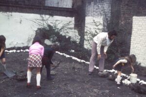 Whitewashing stones in the community garden, 1974