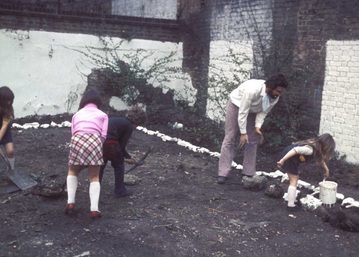 Whitewashing stones in the community garden, 1974