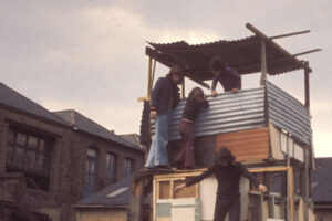 Children playing on a play structure they built themselves on the community garden, 1974
